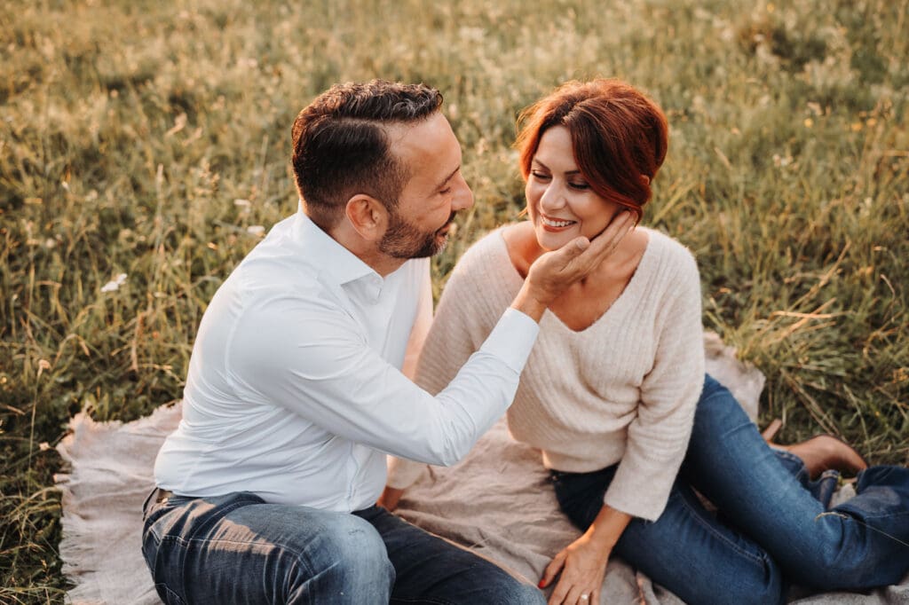 Paar kuschelt sich während eines Fotoshootings aneinander